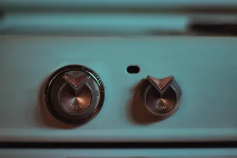 Two knobs on an old turquoise cooker